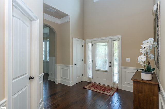 37 Wild Eve Way, Greer, SC 29650 - foyer featuring a wainscoted wall, arched walkways, dark wood-style floors, healthy amount of natural light, and a decorative wall