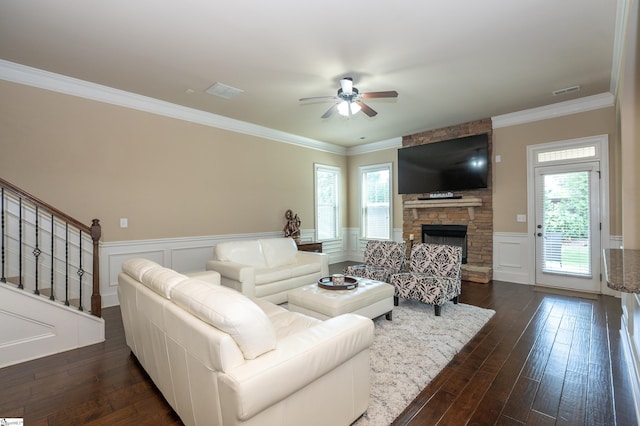 37 Wild Eve Way, Greer, SC 29650 - living area with a ceiling fan, a fireplace, dark wood-style flooring, a wainscoted wall, and crown molding