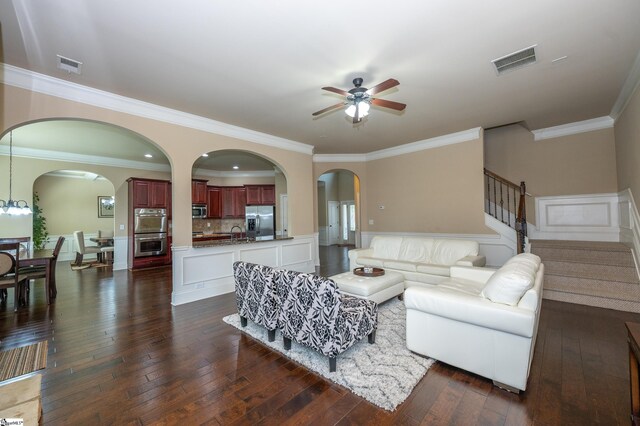 37 Wild Eve Way, Greer, SC 29650 - living area featuring ceiling fan, ornamental molding, stairs, dark wood-style flooring, and arched walkways