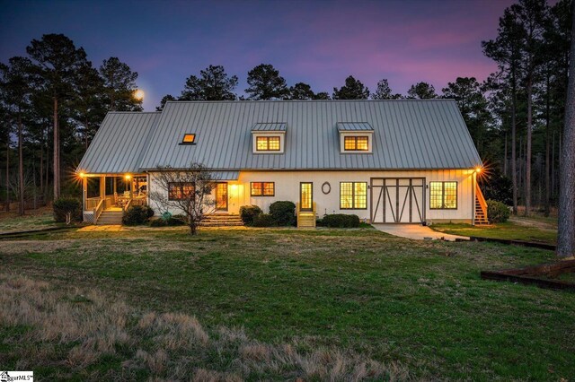 2164 Loncolnton Hwy, Elberton, GA 30635 - back of property at dusk featuring a lawn, metal roof, a standing seam roof, and stairway