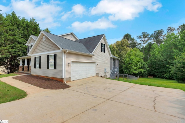 4 Dade Ct, Taylors, SC 29687 - view of side of home with concrete driveway, a lawn, a shingled roof, and an attached garage