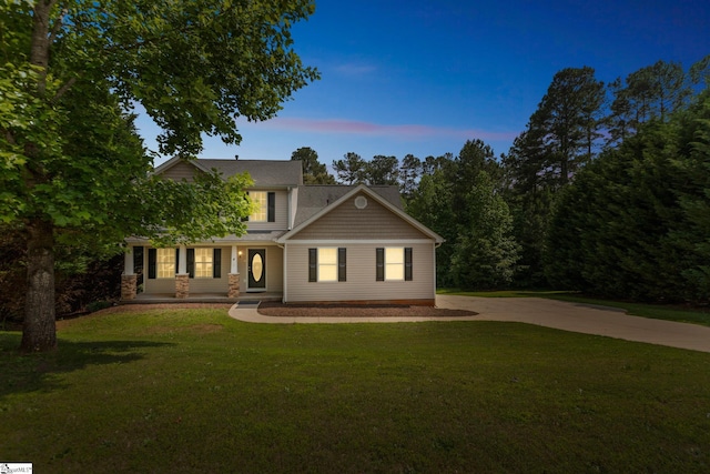 4 Dade Ct, Taylors, SC 29687 - view of front facade featuring a lawn, driveway, covered porch, and stone siding