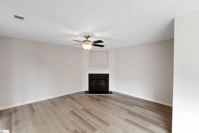 4 Dade Ct, Taylors, SC 29687 - unfurnished living room with light wood-style floors, a ceiling fan, a fireplace, and baseboards