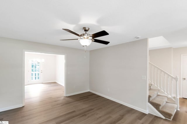 4 Dade Ct, Taylors, SC 29687 - spare room featuring wood finished floors, stairway, baseboards, and ceiling fan