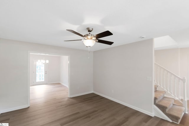4 Dade Ct, Taylors, SC 29687 - spare room featuring wood finished floors, a chandelier, stairs, baseboards, and ceiling fan