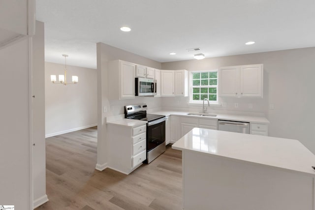 4 Dade Ct, Taylors, SC 29687 - kitchen featuring stainless steel appliances, a sink, light wood-type flooring, white cabinetry, and recessed lighting