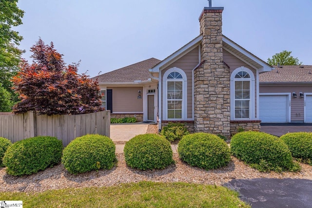 122 Fudora Cir, Simpsonville, SC 29681 - ranch-style house with stone siding, a chimney, and a shingled roof