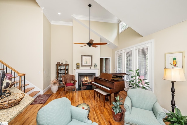 225 Chickadee Trl Unit B, Easley, SC 29642 - living area featuring ornamental molding, wood finished floors, stairway, a warm lit fireplace, and ceiling fan
