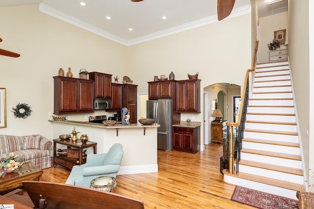 225 Chickadee Trl Unit B, Easley, SC 29642 - living area with arched walkways, stairway, light wood-style flooring, ornamental molding, and ceiling fan