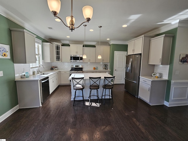 700 Citrine Way, Duncan, SC 29334 - kitchen featuring stainless steel appliances, a sink, ornamental molding, a kitchen island, and backsplash