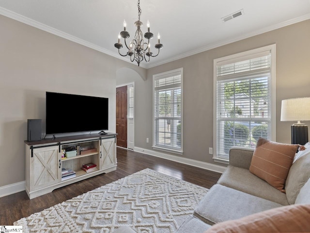 125 Saxon Falls Ct, Greenville, SC 29607 - living room with baseboards, ornamental molding, a chandelier, arched walkways, and dark wood-style flooring