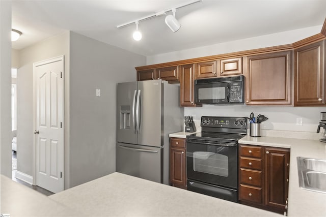 125 Saxon Falls Ct, Greenville, SC 29607 - kitchen featuring black appliances, light countertops, track lighting, and brown cabinets
