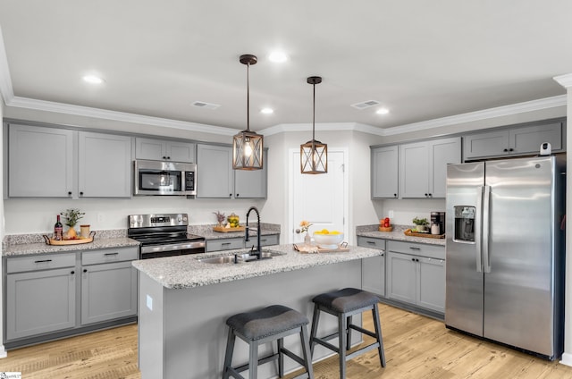 7110 Luna Mae Ct, Boiling Springs, SC 29316 - kitchen featuring stainless steel appliances, gray cabinets, a sink, ornamental molding, and light stone countertops