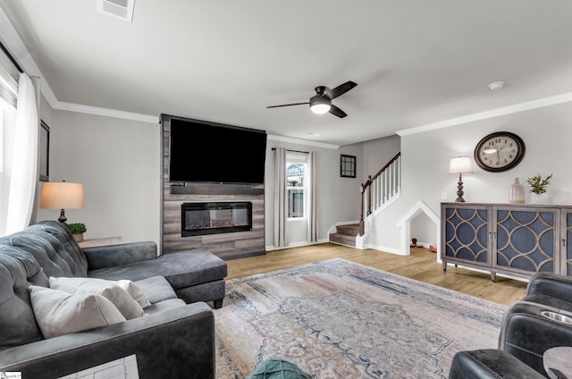 7110 Luna Mae Ct, Boiling Springs, SC 29316 - living room with stairs, ceiling fan, crown molding, wood finished floors, and baseboards
