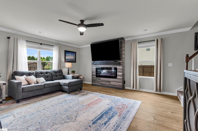7110 Luna Mae Ct, Boiling Springs, SC 29316 - living room with a fireplace, crown molding, a ceiling fan, wood finished floors, and baseboards