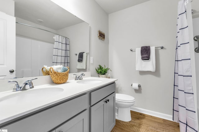 7110 Luna Mae Ct, Boiling Springs, SC 29316 - bathroom featuring double vanity, wood finished floors, toilet, and baseboards