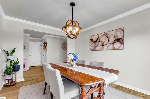7110 Luna Mae Ct, Boiling Springs, SC 29316 - dining space featuring wood finished floors, a chandelier, baseboards, and crown molding