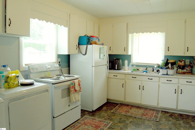 210 Mcdowell St, Laurens, SC 29360 - kitchen with white appliances, a sink, washer / dryer, light countertops, and stone finish flooring