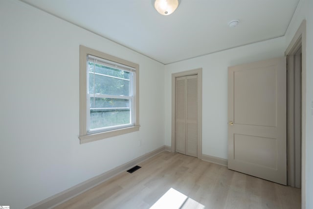 32 Essex Ct, Greenville, SC 29609 - unfurnished bedroom with light wood-type flooring and a closet