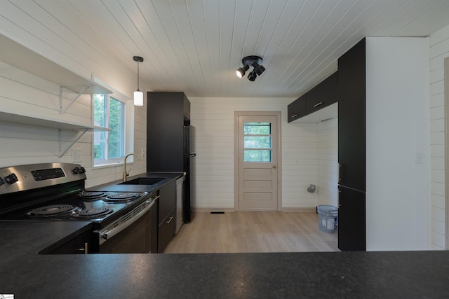 32 Essex Ct, Greenville, SC 29609 - kitchen featuring stainless steel appliances, dark countertops, dark cabinetry, light wood-type flooring, and pendant lighting