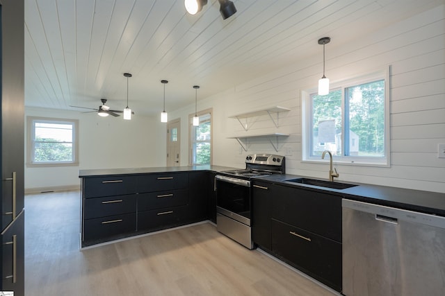 32 Essex Ct, Greenville, SC 29609 - kitchen with appliances with stainless steel finishes, dark countertops, a peninsula, a ceiling fan, and light wood-style flooring