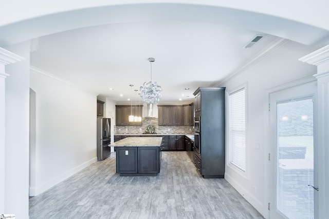 740 N Alamosa Dr, Boiling Springs, SC 29316 - kitchen with ornamental molding, wall chimney exhaust hood, a sink, tasteful backsplash, and a chandelier
