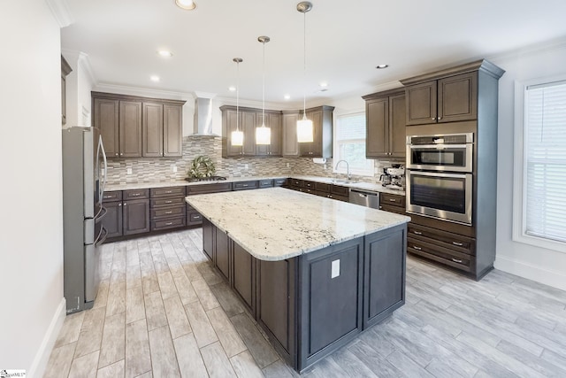 740 N Alamosa Dr, Boiling Springs, SC 29316 - kitchen with appliances with stainless steel finishes, wall chimney range hood, a kitchen island, baseboards, and tasteful backsplash