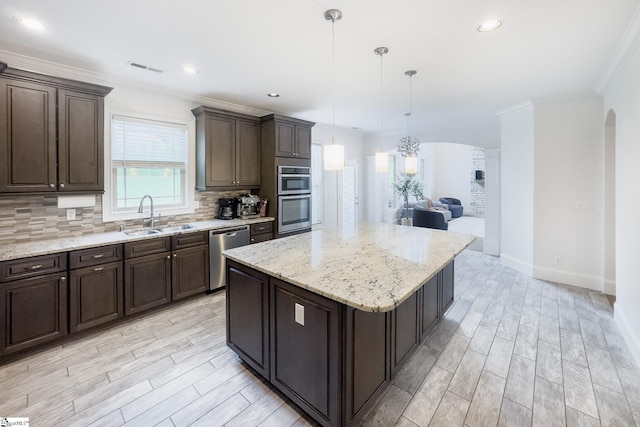 740 N Alamosa Dr, Boiling Springs, SC 29316 - kitchen with a sink, stainless steel appliances, backsplash, dark brown cabinets, and arched walkways
