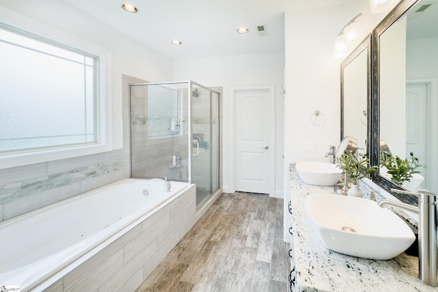 740 N Alamosa Dr, Boiling Springs, SC 29316 - bathroom featuring a whirlpool tub, a stall shower, double vanity, wood finished floors, and recessed lighting