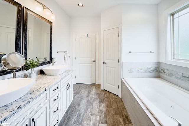 740 N Alamosa Dr, Boiling Springs, SC 29316 - full bathroom with double vanity, a garden tub, wood finished floors, and recessed lighting