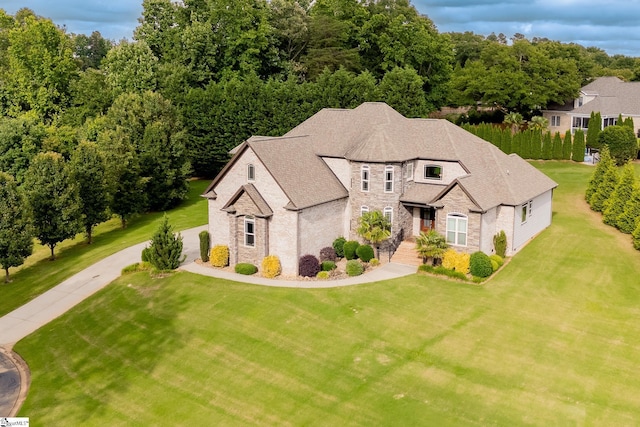 740 N Alamosa Dr, Boiling Springs, SC 29316 - french provincial home with stone siding, a front yard, driveway, and roof with shingles