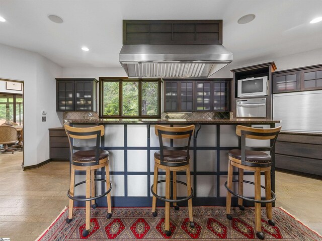 380 Montagu Dr, Spartanburg, SC 29301 - bar with backsplash, recessed lighting, wall chimney range hood, a warming drawer, and baseboards