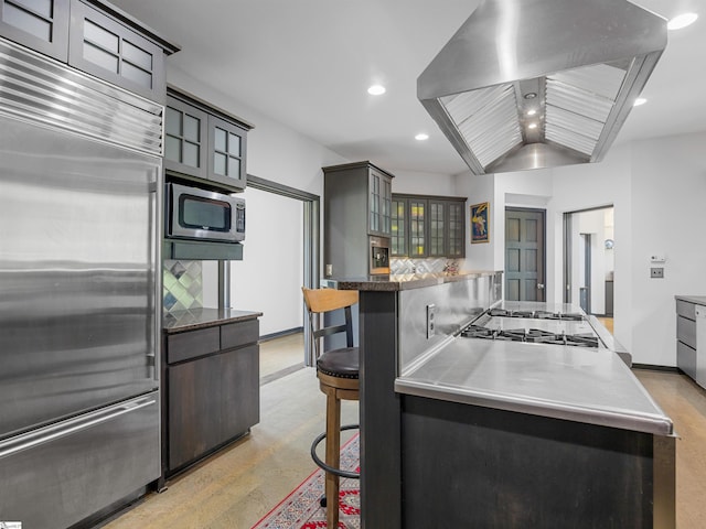 380 Montagu Dr, Spartanburg, SC 29301 - kitchen featuring stainless steel appliances, exhaust hood, recessed lighting, a breakfast bar area, and stainless steel countertops