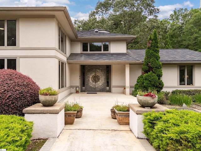 380 Montagu Dr, Spartanburg, SC 29301 - doorway to property featuring stucco siding, a patio area, and roof with shingles