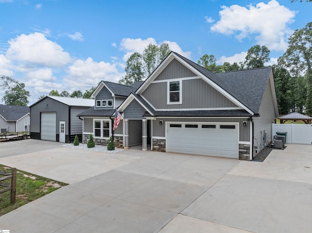 197 Falling Creek Rd, Spartanburg, SC 29301 - craftsman house with stone siding, a shingled roof, concrete driveway, and central AC