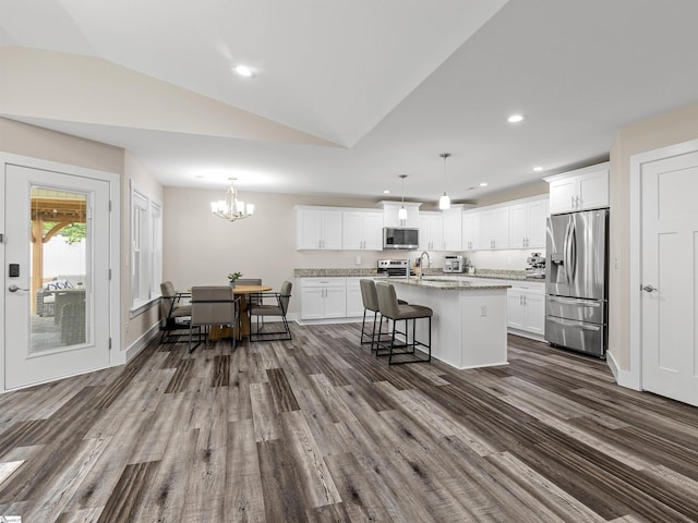 197 Falling Creek Rd, Spartanburg, SC 29301 - kitchen with stainless steel appliances, dark wood finished floors, a center island with sink, a sink, and lofted ceiling