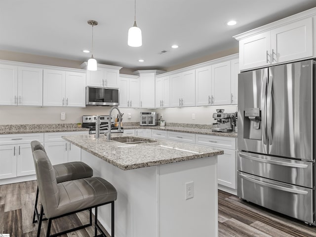 197 Falling Creek Rd, Spartanburg, SC 29301 - kitchen with appliances with stainless steel finishes, a sink, white cabinetry, dark wood finished floors, and recessed lighting