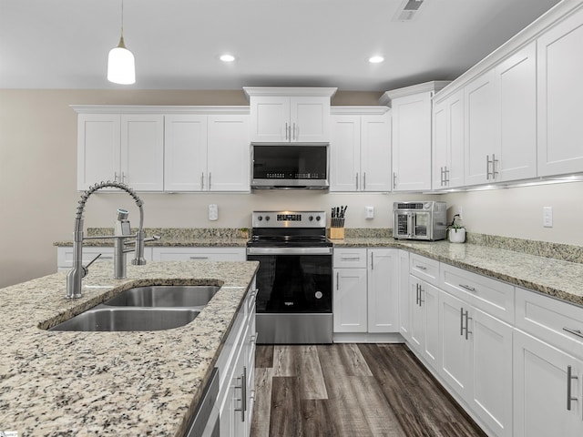 197 Falling Creek Rd, Spartanburg, SC 29301 - kitchen with appliances with stainless steel finishes, a sink, white cabinetry, recessed lighting, and hanging light fixtures