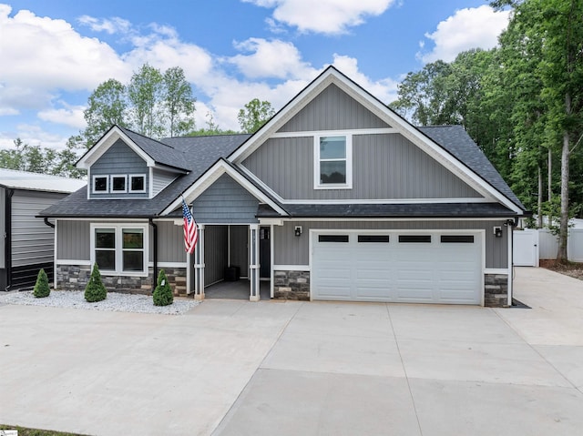 197 Falling Creek Rd, Spartanburg, SC 29301 - craftsman-style home featuring concrete driveway, stone siding, roof with shingles, and an attached garage
