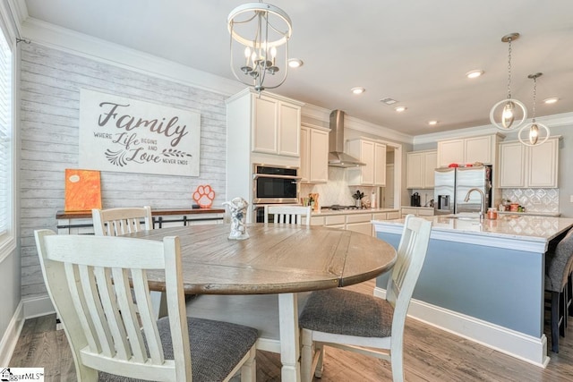 2 Stony Run Ln, Simpsonville, SC 29681 - dining space featuring a chandelier, ornamental molding, recessed lighting, light wood-style flooring, and wood walls