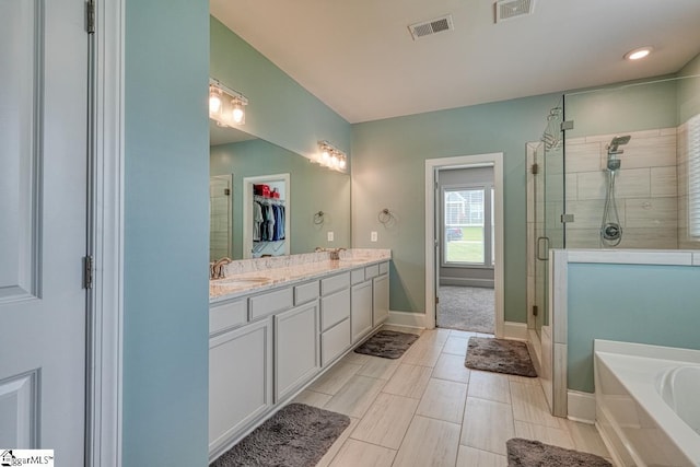 2 Stony Run Ln, Simpsonville, SC 29681 - full bathroom with a shower stall, double vanity, a bath, a spacious closet, and baseboards