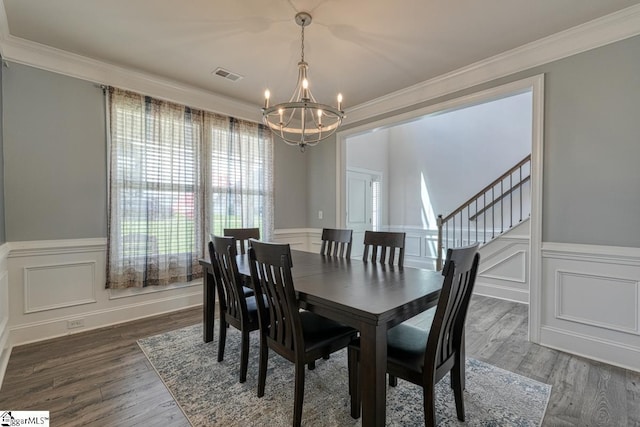 2 Stony Run Ln, Simpsonville, SC 29681 - dining room featuring a chandelier, crown molding, wood finished floors, a decorative wall, and stairs