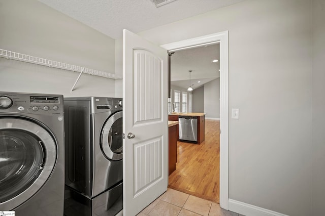 157 Deyoung Meadows Dr, Greer, SC 29651 - laundry area with washing machine and clothes dryer, light tile patterned floors, and baseboards