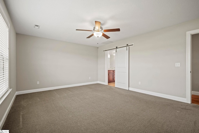 157 Deyoung Meadows Dr, Greer, SC 29651 - unfurnished bedroom with a barn door, carpet, and baseboards