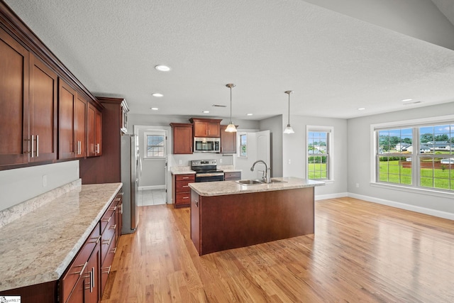 157 Deyoung Meadows Dr, Greer, SC 29651 - kitchen featuring appliances with stainless steel finishes, a sink, light wood-style floors, baseboards, and a kitchen island with sink
