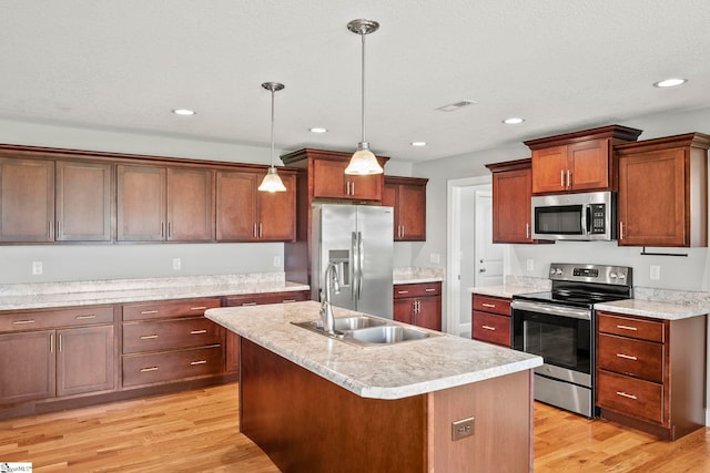 157 Deyoung Meadows Dr, Greer, SC 29651 - kitchen with appliances with stainless steel finishes, a sink, hanging light fixtures, light countertops, and light wood-style floors