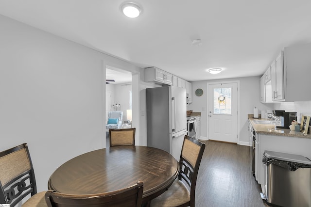 316 W Blue Ridge St, Pendleton, SC 29670 - dining space with dark wood-style flooring and baseboards