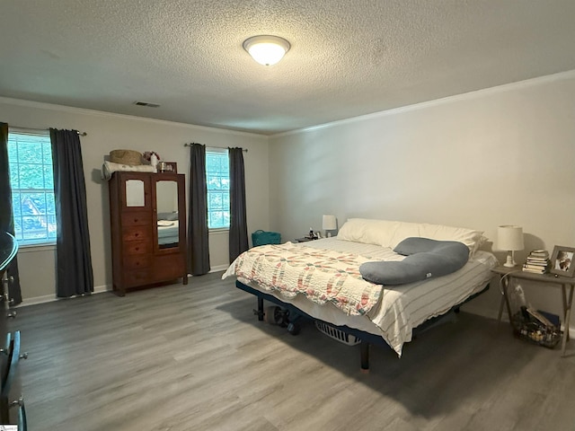 111 Firethorne Ct, Greer, SC 29650 - bedroom featuring wood finished floors, crown molding, a textured ceiling, and baseboards