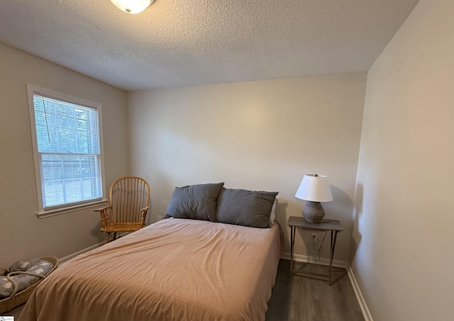 111 Firethorne Ct, Greer, SC 29650 - bedroom featuring wood finished floors, a textured ceiling, and baseboards