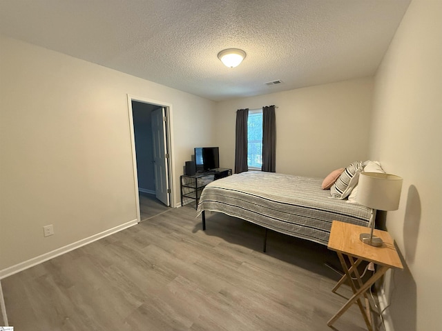 111 Firethorne Ct, Greer, SC 29650 - bedroom with wood finished floors, a textured ceiling, and baseboards
